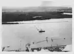 Anti-submarine boom (net) at Fort Lytton during the Second World War. Two moving boom gates were operated by winches located at the fort and on the permanently anchored ship.