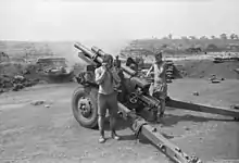 A black and white image of a New Zealand howitzer during Operation Coburg