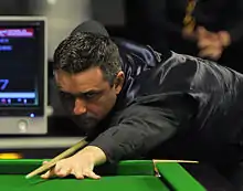 Alan McManus playing a shot