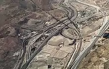 Abandoned baja part of Smeltertown is left of center here, with the American Dam Headquarters (white building) in it, near the American Dam on the Rio Grande, in this aerial view from over downtown El Paso.  La Calavera is at upper right.