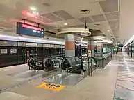 View of the CCL island platform, with a pair of escalators leading downwards from the platforms.