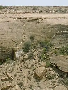 A color picture of two sets of steps cut deep into a cliff