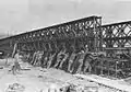 U.S. combat engineers slide stacked doubled sections of Bailey bridging into place at Wesel on the Rhine in Germany (c. 1945)