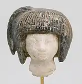 Head from a spoon in the form of a swimming girl; 1390–1353&nbsp;BC; travertine (the head) and steatite (the hair); 2.8 × 2.7&nbsp;cm; Metropolitan Museum of Art