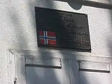 Plate marking donation from Government of Norway and Norwegian Refugee Council from 1997