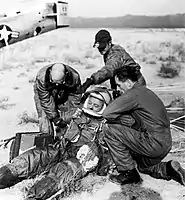 A ground crew assists Joe Kittinger in removing his flight gear after the successful flight of Excelsior III. Despite the appearances, Kittinger was fine.