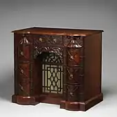 Kneehole writing table; circa 1760; mahogany, mahogany veneer and gilt bronze; 88.9 × 97.8 × 62.2&nbsp;cm; Metropolitan Museum of Art (New York City)