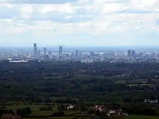 View of Manchester from Hartshead Pike, 8 miles (13&nbsp;km) away with Fiddlers Ferry Power Station beyond,  27 miles (43&nbsp;km) away.