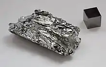 Molybdenum crystals and a 1&nbsp;cm3 molybdenum cube for comparison