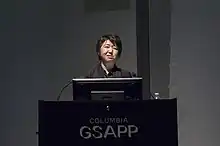 Kaijima giving a lecture in front of a podium