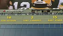 A photo of the retired numbers above the stands at Lambeau Field. Tony Canadeo's #3 is the focus of the image.
