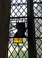 Medieval glass fragment to Sir John Welby in the south aisle east window