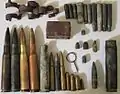 Artifacts found at the former Sahuarita Air Force Range, including a 20&nbsp;mm anti-aircraft gun casing and belt link, M2 bullets and casings, M1919 bullets, casings, and a machine gun belt link, M1 Garand bullets, casings, and a stripper clip, M1 Carbine bullets and casings, M1911 bullets and casings, a .22 bullet and casing, some unidentified casings, and an Mk 2 grenade pin.