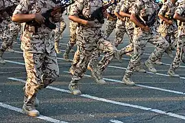 Saudi Arabia National Guardsmen run past in three-colour desert DPM.