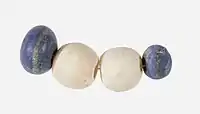 String of beads; 3650–3100 BC; lapis lazuli (the blue beads) and travertine (the white beads) (Egyptian alabaster); length: 4.5 centimetres (1.8&nbsp;in); by Naqada II or Naqada III cultures; Metropolitan Museum of Art (New York City)