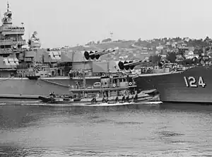 USS Awatobi (YTB-264) assists USS Rochester in departing Mare Island Naval Shipyard on 20 September 1953.