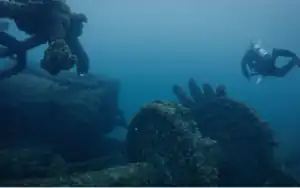 A diver swims near a shipwreck.